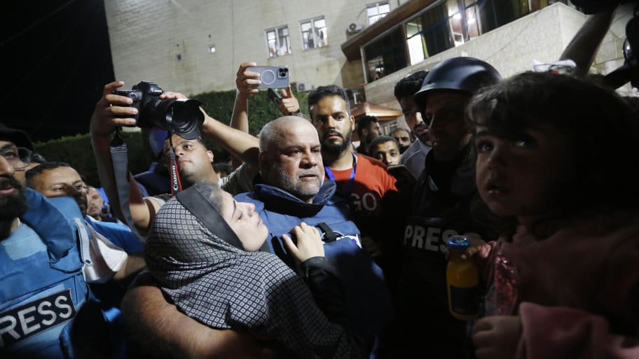 Al Jazeera reporter Wael al-Dahdouh surrounded by a crowd in Gaza.