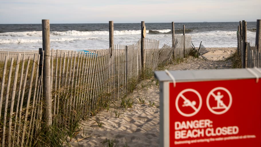 A "Beach closed" sign is seen at an entrance to the beach, during the outbreak of the coronavirus disease (COVID-19), in the Rockaway section of Queens in New York City, U.S., May 20, 2020.