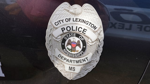 A police shield is displayed on a Lexington, Mississippi police cruiser
