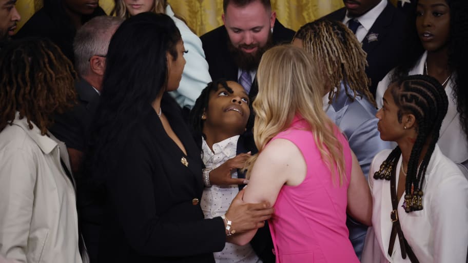 Louisiana State University team member Sa'Myah Smith (C) is supported by her teammates while collapsing during a celebration of the team's NCAA Division I women's basketball national championship in the East Room of the White House.