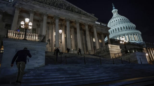 Members of the U.S. House of Representatives walk up the steps of the U.S. Capitol.
