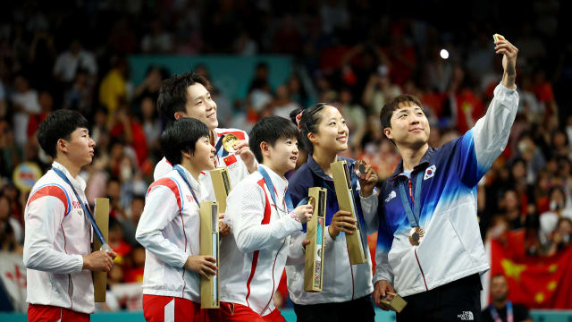 Bronze medallist Jonghoon Lim of South Korea takes selfie with Yubin Shin of South Korea and gold medallists Chuqin Wang of China and Yingsha Sun of China with silver medallists Jong Sik Ri of North Korea and Kum Yong Kim of North Korea