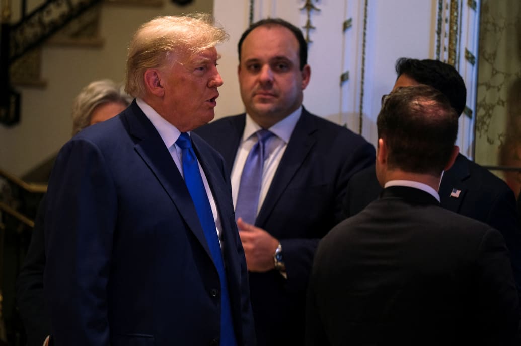 President Donald Trump speaks with aides including Boris Epshteyn, at his Mar-a-Lago resort on the night of the 2022 U.S. midterm elections in Palm Beach, Florida