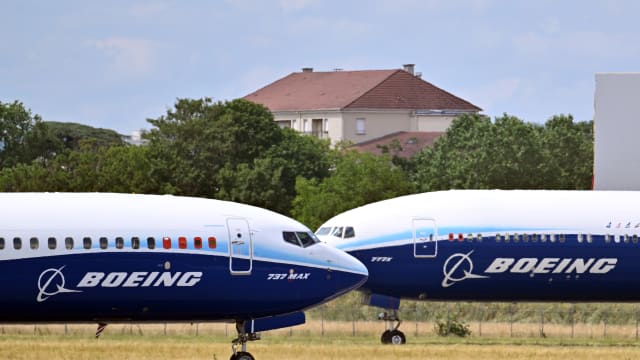 A Boeing 737-10 Max (L) prepares to take off in front of a Boeing 777-9 (R) at the 54th International Paris Air Show at Le Bourget Airport, north of Paris, France on June 21, 2023.