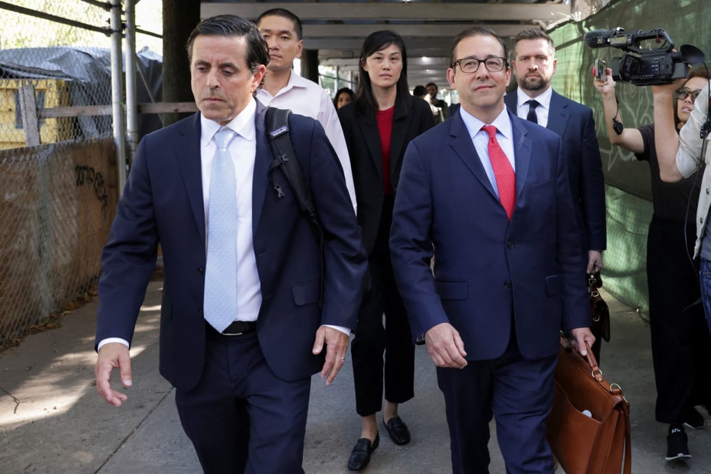 Linda Sun, a former aide to New York State Governor Kathy Hochul, exits Brooklyn Federal court accompanied by Chris Hu and lawyers.