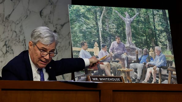 Senate Judiciary Committee member Sen. Sheldon Whitehouse (D-RI) displays a copy of a painting featuring Supreme Court Associate Justice Clarence Thomas.
