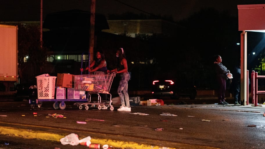 People walking through Philadelphia with looted merchandise
