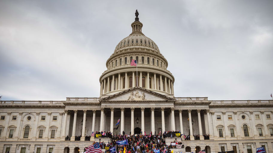 A large group of pro-Trump protesters stand on the East steps of the Capitol Building after storming its grounds on January 6, 2021 in Washington, DC.