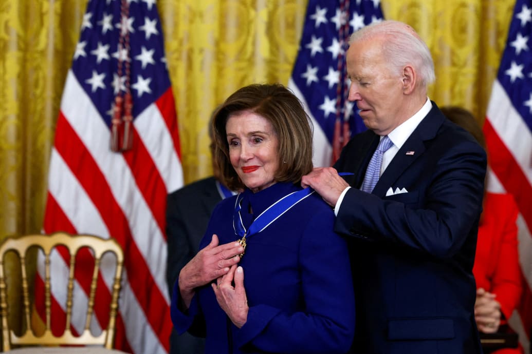 President Joe Biden puts the Presidential Medal of Freedom around the neck of former House Speaker Nancy Pelosi, who holds her hands over the medalion, during a ceremony at the White House in 2024.