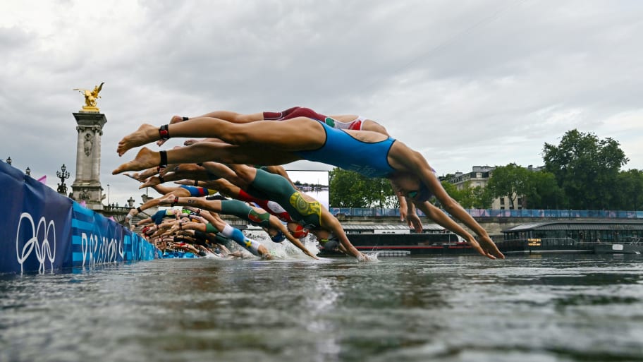  Athletes compete in the swimming race in the Seine during the women's individual triathlon at the Paris 2024 Olympic Games at Pont Alexandre III on July 31, 2024 in Paris, France. 