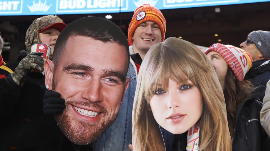 Fans hold large pictures of Travis Kielce and Taylor Swift 