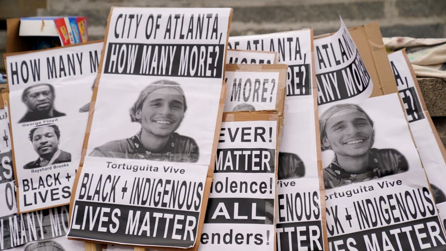 Signs with the image of Manuel Teran that read "City of Atlanta, how many more? Tortuguita Vive. Black + Indigenous Lives Matter."