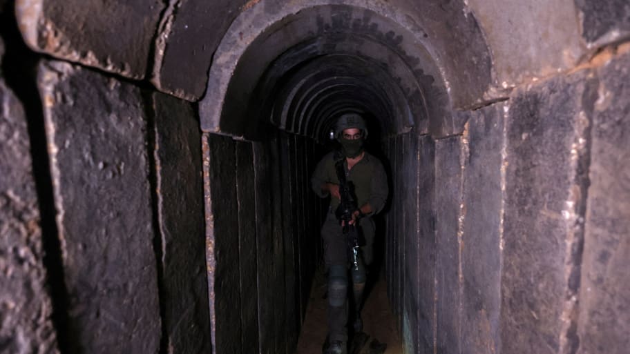 An Israeli soldier walks through a tunnel underneath Al Shifa Hospital in Gaza City, amid the ongoing ground operation of the Israeli army against Palestinian Islamist group Hamas