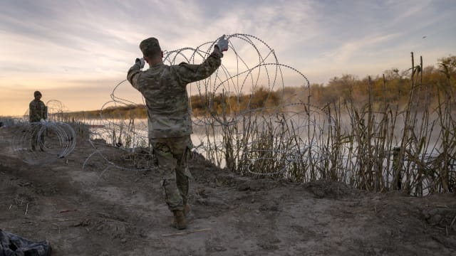 Texas National Guard soldiers install additional razor wire lie along the Rio Grande on January 10, 2024 in Eagle Pass, Texas.