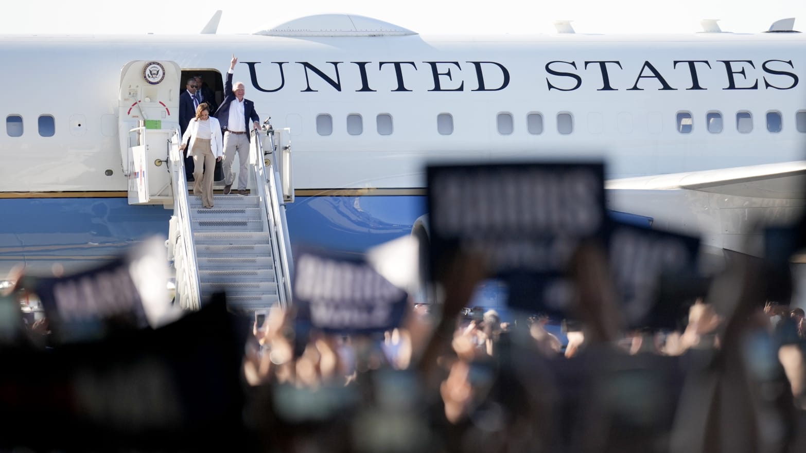 Democratic U.S. presidential candidate Vice President Kamala Harris and Democratic vice presidential candidate Minnesota Gov. Tim Walz walk off an aircraft.