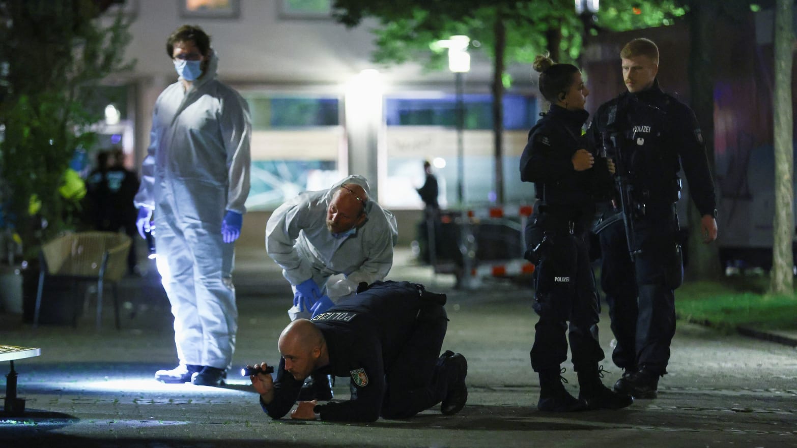 Police members and forensic experts work after a man randomly stabbed passers-by with a knife at a city festival, in Solingen, Germany.