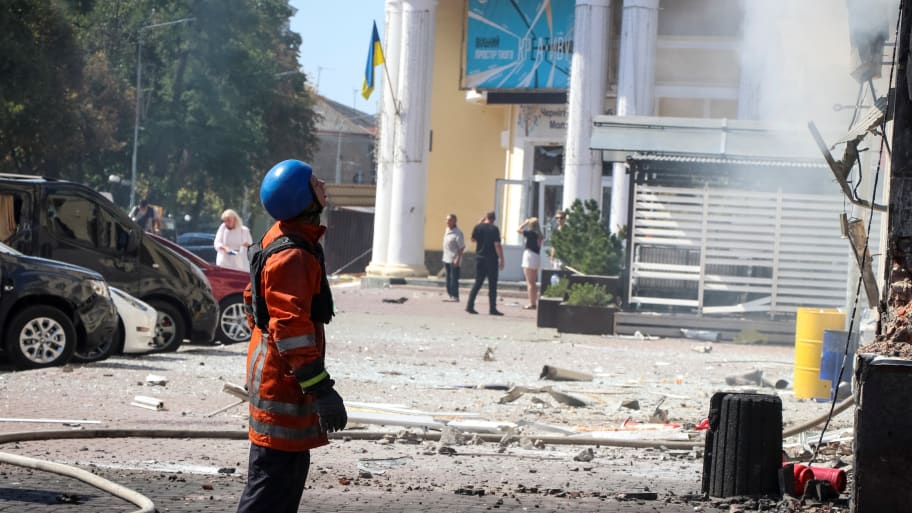 An emergency service worker stands at the site of a Russian missile strike on Chernihiv, Ukraine