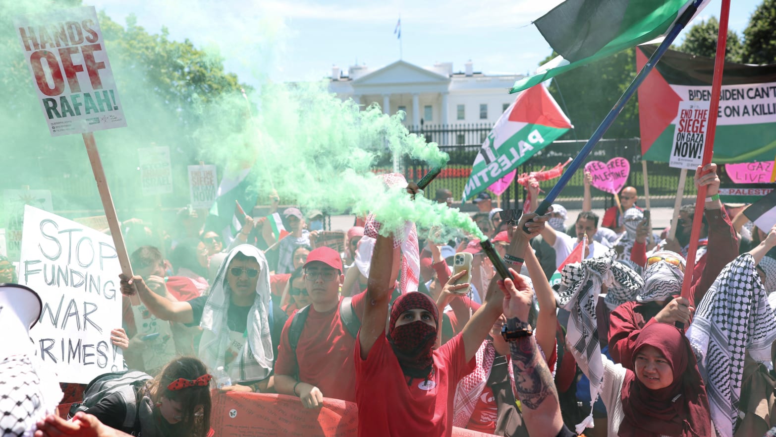 Demonstrators hold smoke flares outside the White House.