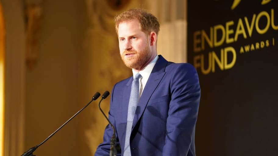 Prince Harry speaks at a podium.