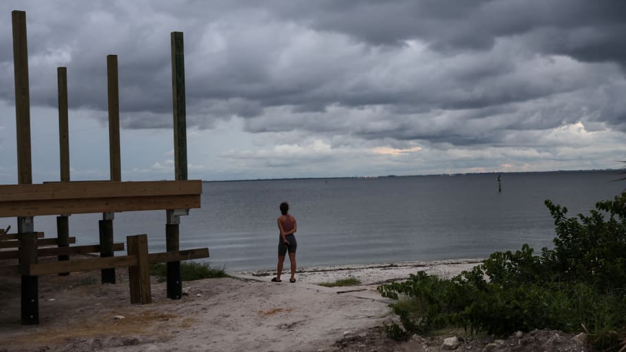Nyasia Arzuaga looks out at storm clouds, as Hurricane Ian spun toward the state carrying high winds, torrential rains and a powerful storm surge, at Ben T. Davis Beach in Tampa, Florida.