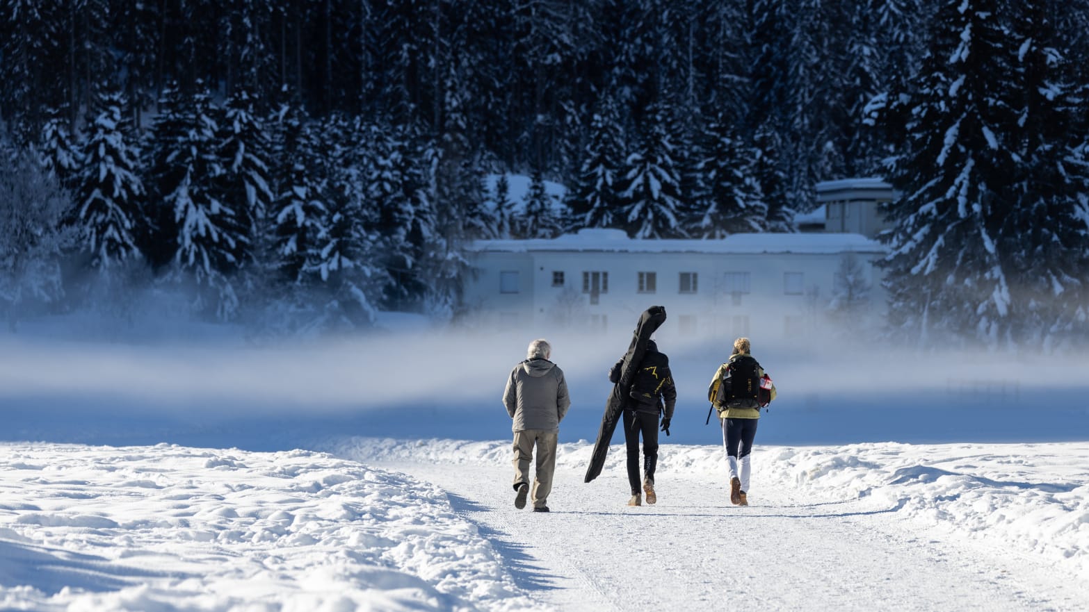 Switzerland, Davos: People walking along a ski slope.
