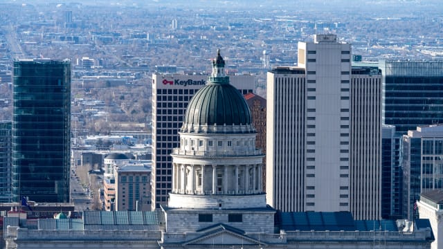 The Utah State Capitol dome wth downtown Salt Lake City, Utah behind.