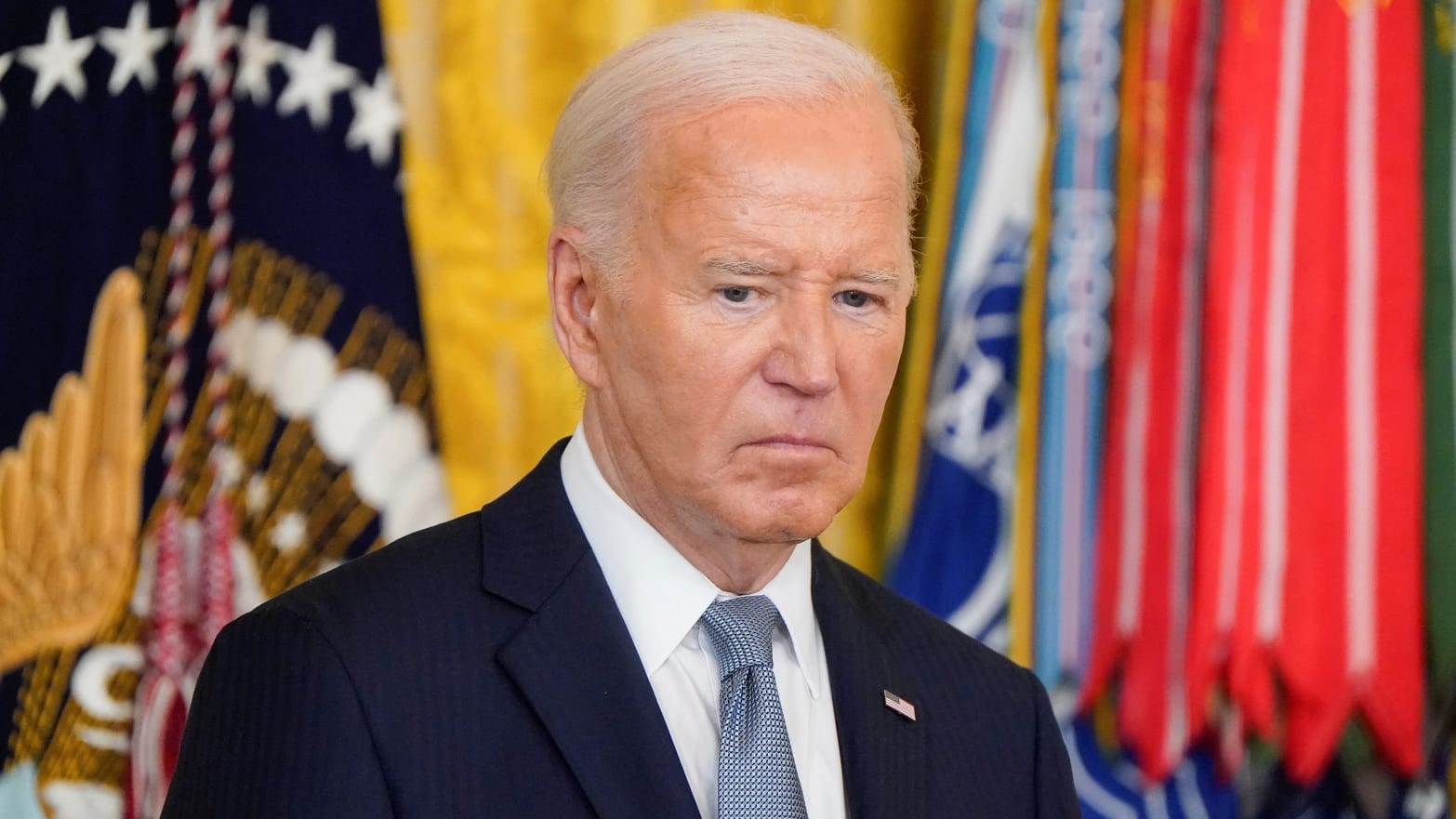Joe Biden stares down while at a ceremony in the White House.