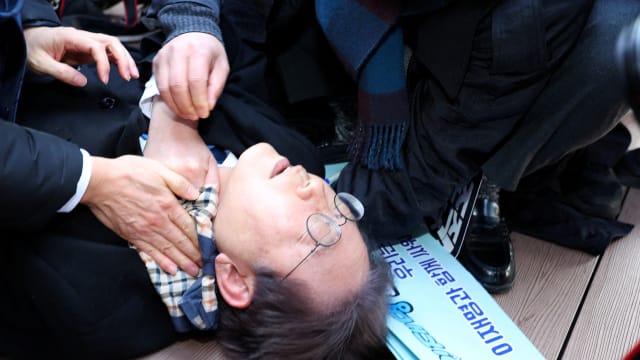 South Korea's opposition party leader Lee Jae-myung falls after being attacked