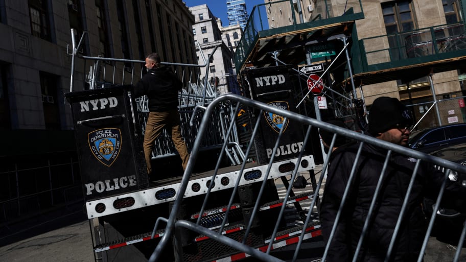 Men set up NYPD barricades outside Manhattan Criminal Court in New York City