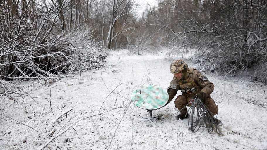 A soldier disconnects their Starlink on the front line at Orthodox Christmas, during a ceasefire announced by Russia over the Orthodox Christmas period, from the frontline region of Kreminna, Ukraine, January 6, 2023. 
