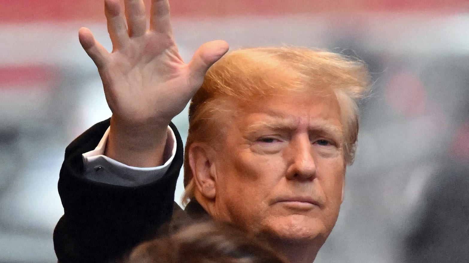 Former President Donald Trump waves as he departs for his sexual assault defamation trial in New York