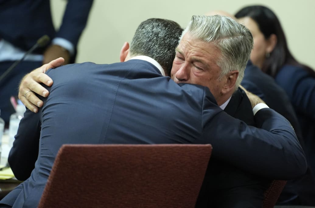 Alec Baldwin hugs his attorney Alex Spiro after his trial for involuntary manslaughter was dismissed by a judge Friday