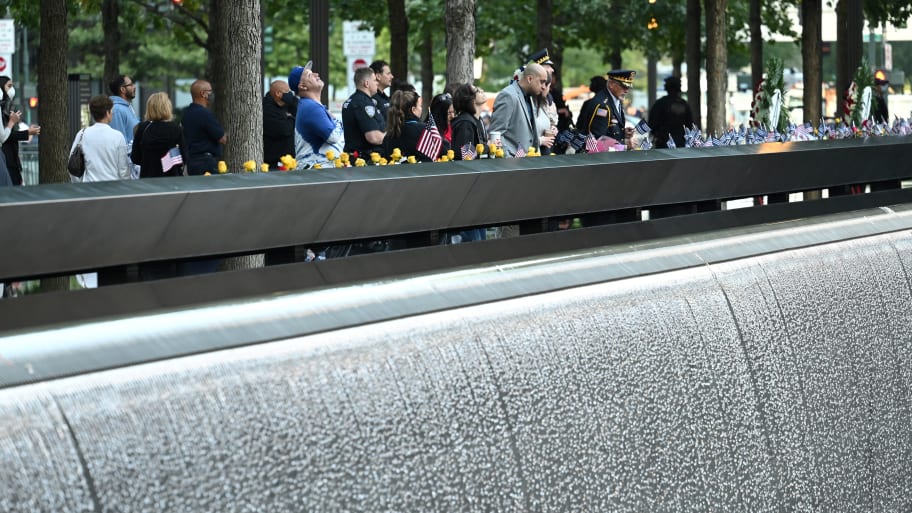 Mourners stand at the South Tower ahead ceremonies commemorating the 20th anniversary of the September 11 attacks, in New York City, U.S., September 11, 2021. 