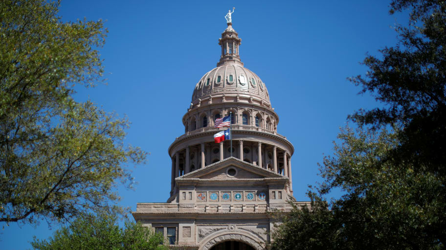 The U.S flag and the Texas State flag fly over the Texas State Capitol as the state Senate debates the #SB6 bathroom bill in Austin, Texas, March 14, 2017. 