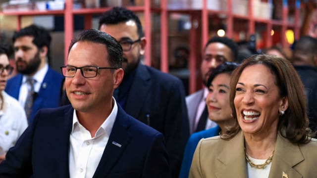 Kamala Harris and Josh Shapiro smiling with a crowd behind them 