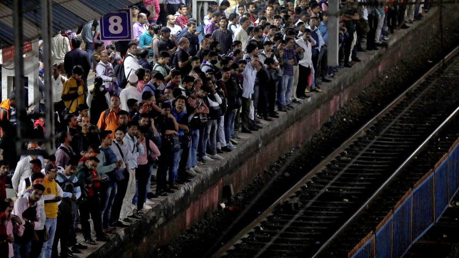 Commuters crowd on a platform as they wait to board suburban trains at a railway station in Mumbai, India, January 20, 2023. 