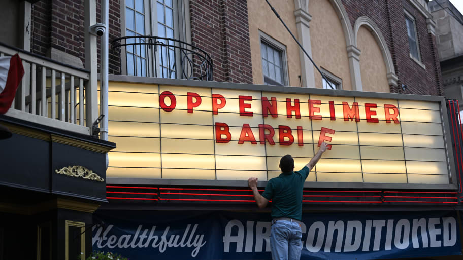 An employee adds letters for upcoming film releases "Oppenheimer" and "Barbie" to a marquee at the Colonial Theater on July 16, 2023 in Phoenixville, Pennsylvania.