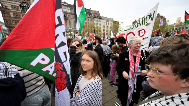 Climate activist Greta Thunberg stands in a crowd at the protest