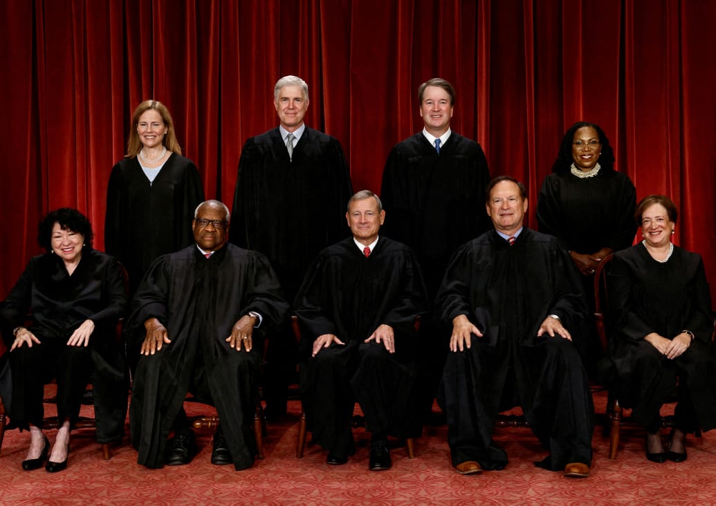 Supreme Court justices: Seated (L-R): Justices Sonia Sotomayor, Clarence Thomas, Chief Justice John G. Roberts, Jr., Samuel A. Alito, Jr. and Elena Kagan. Standing (L-R): Amy Coney Barrett, Neil M. Gorsuch, Brett M. Kavanaugh and Ketanji Brown Jackson.