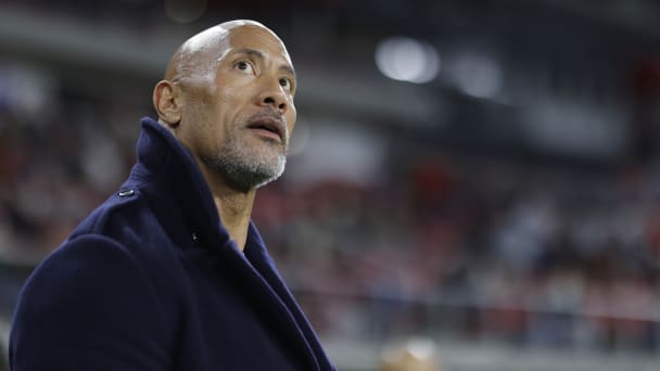 XFL co-owner Dwayne Johnson watches the game between the D.C. Defenders and the Seattle Sea Dragons from the sideline during the second quarter at Audi Field. 