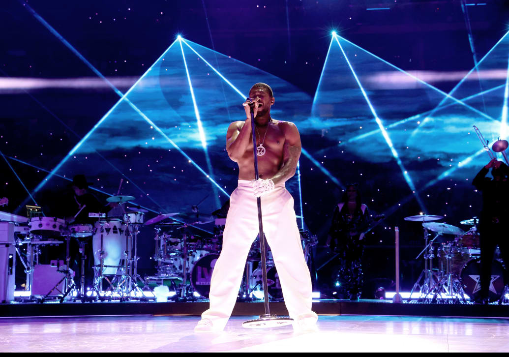 Photo of Usher shirtless singing at the Super Bowl Halftime Show