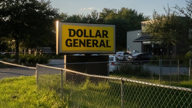 Police investigators continue to work at a Dollar General store a day after a white man armed with a high-powered rifle and a handgun killed three Black people before shooting himself