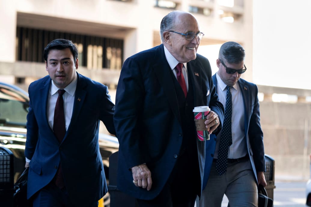 Rudy Giuliani smiles as he arrives at a Washington, D.C., courthouse on Friday.