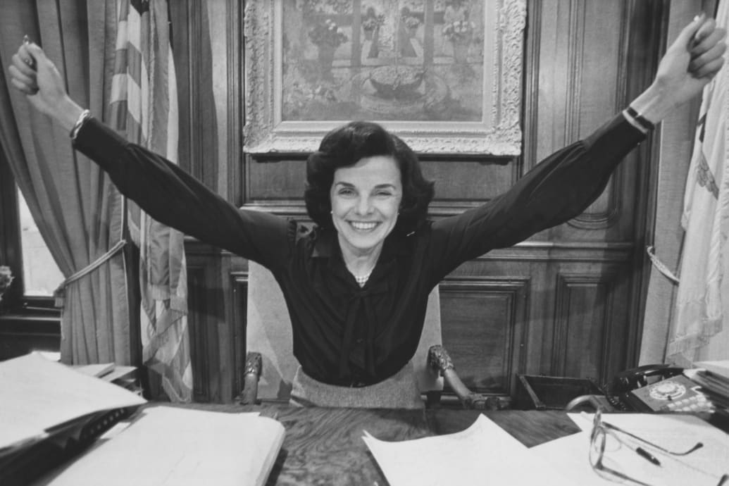 Dianne Feinstein, her arms outstretched in celebration, in her office after she was elected mayor of San Francisco, at San Francisco City Hall in San Francisco, California, circa 1978.