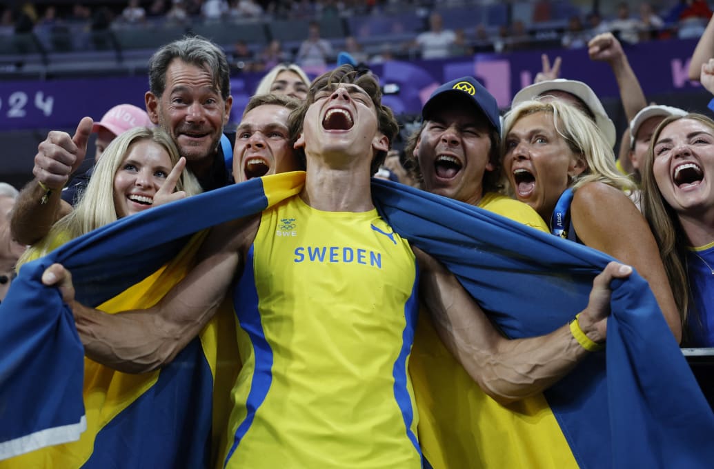 Mondo Duplantis of Sweden celebrates after winning gold in the men's pole vault competition at the 2024 Olympic Games.