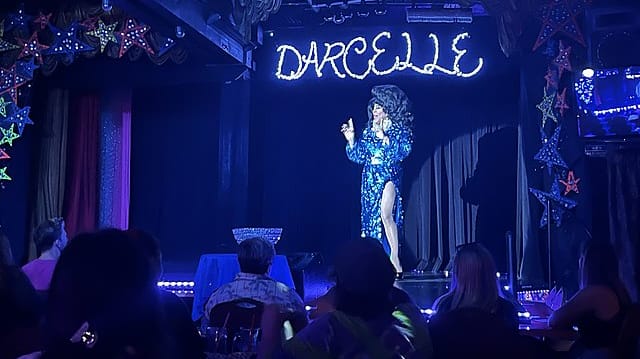 Darcelle performing on stage in August 2022.