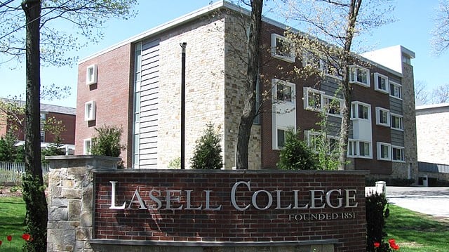 A photo of Lasell University sign in front of the campus.