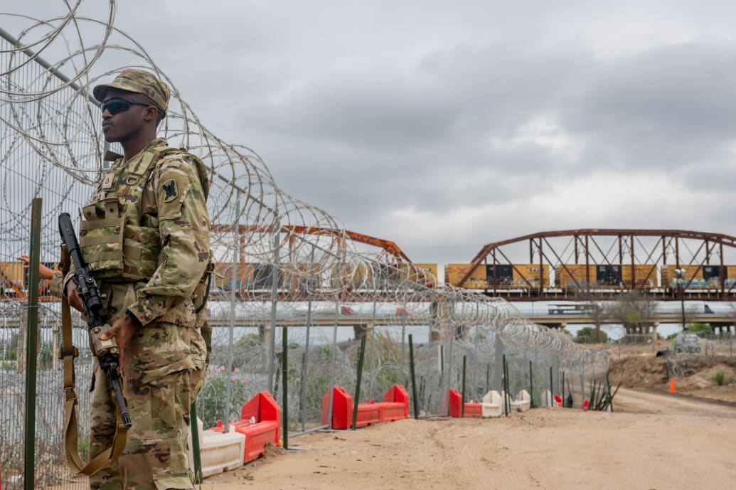 A Texas National Guard soldier patrols near the Rio Grande river at Shelby Park in Eagle Pass, Texas. 