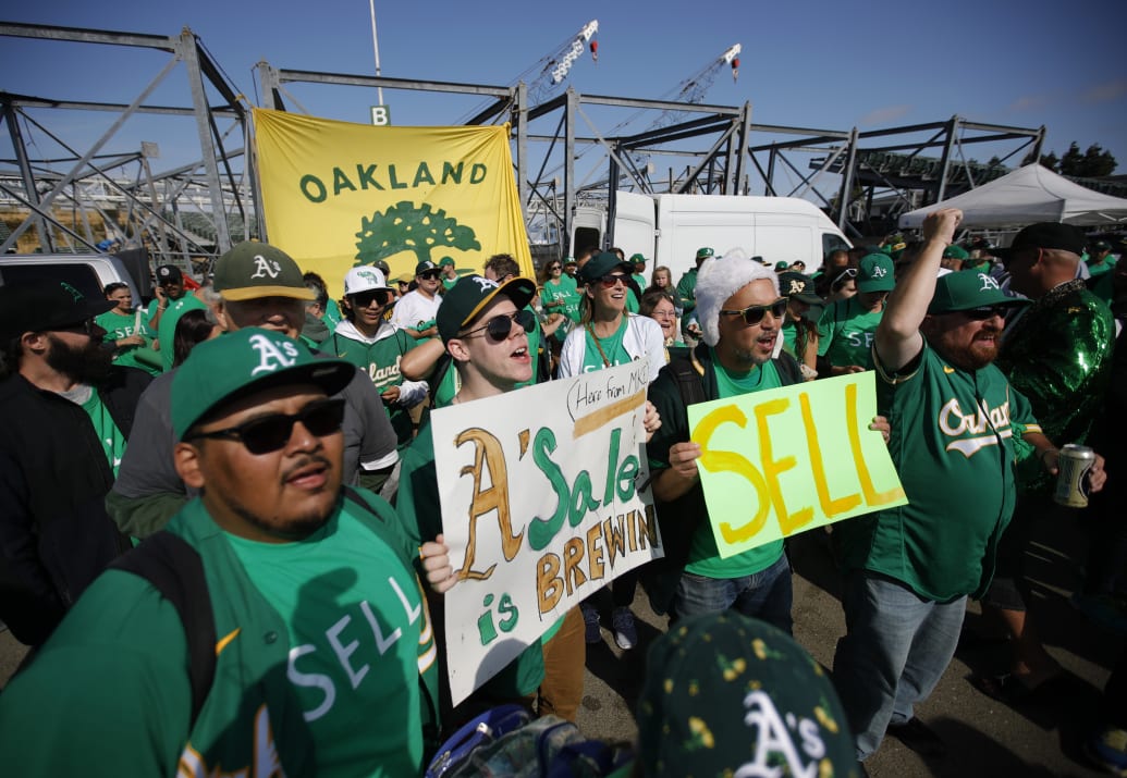 Oakland Athletics fans chant “Sell the team.”