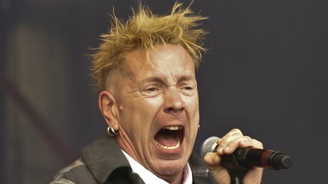 John Lydon singing into a microphone.